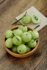  Fresh gooseberries in wooden bowl,Close up 