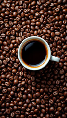 Fototapeta premium Top-down shot of glossy Arabica beans with espresso cup and rich crema