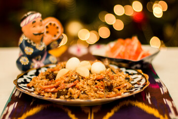 Colorful plate of traditional Pilaf Uzbek rice dish garnished with quail eggs and served alongside fresh fruits, showcasing vibrant culinary heritage and cultural richness. Copy space, menu
