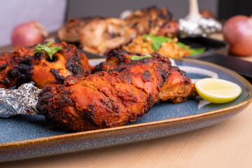 Crispy delicious chicken tandoori and Afghani chicken tandoori  with salad served in plate. Tandoori Chicken is an Indian non vegetarian spicy food