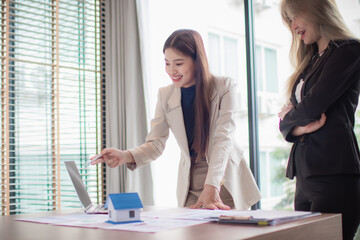 Two professionals shaking hands in the office. Signing a contract. Trust and cooperation. Real estate deal. Investment planning. Success. Teamwork and smiles.