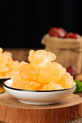 Yellow Rock Candy Crystals in Bowl - Traditional Handmade Sugar Confectionery Cubes on Wooden Background