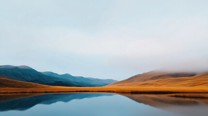 Serene Landscape with Mountains and Calm Water Reflection Under Soft Blue Sky and Misty Clouds