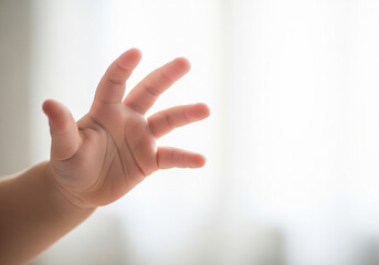 Close up of a child hand with gesture of reaching