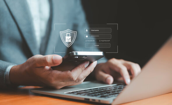 Businessman using smartphone and laptop with digital login security interface, representing cybersecurity, data protection, password authentication, online privacy, and digital identity management.