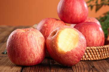 Fresh Red Fuji Apples from Shandong China in Wicker Basket on Wooden Table