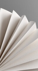 Close-up of folded, light beige paper fanning out