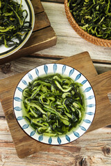 Chinese Dried Cucumber Strips from Northeast China in Traditional Bowls on Wooden Table