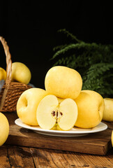 Fresh Golden Yellow Apples on Rustic Wooden Table with Wicker Basket