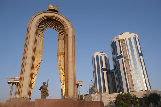 Dushanbe, Tajikistan - 8 September 2025: Scenery of center of Dushanbe, capital of Tajikistan. Monument of Ismail Samani and blue modern building