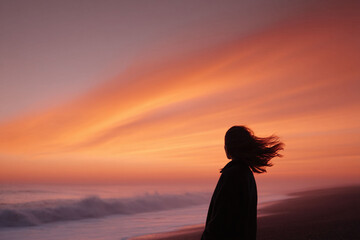 Silhouette of a woman gazing at a stunning orange sunset over the ocean. Evokes peace, reflection, and the beauty of nature. Ideal for travel, wellness, and inspirational content.