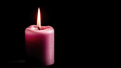 Single pink candle flame against black background