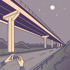 Person captures the glowing highway with phone amidst the serene night landscape