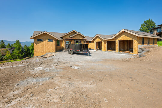 A large contemporary custom home under construction with three car garage in an affluent community of view homes.