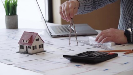 Planner or designer designing at a laptop - Powered by Adobe