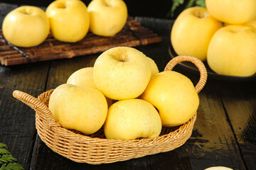 Fresh Golden Yantai Apples in Wicker Basket on Rustic Wooden Table - Premium Quality Fruit Display
