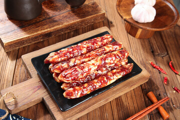 Air-dried sausages on wooden board with garlic and spices, traditional charcuterie meat preparation