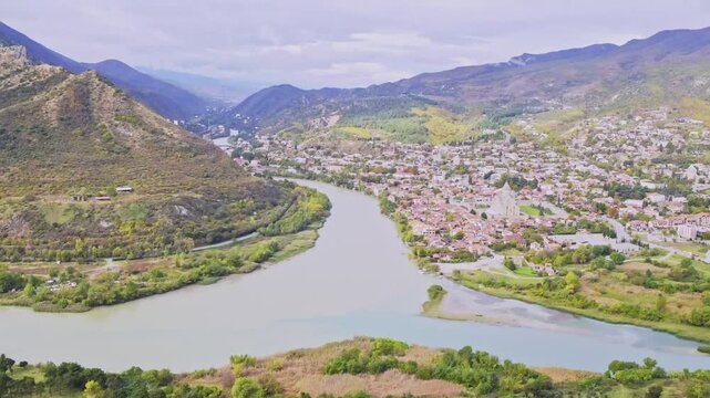 The scenery of the Aragvi & Mtkvari rivers and a highway running alongside iti in Mtskherta city, Georgia. The rivers with different colors are calm.