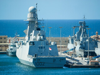 05.04.2025 Alexandria, Egypt - Egyptian navy warship number 1002 docked at Alexandria naval base, modern military vessel with radar tower and naval fleet in background. © Maritime Art Blog