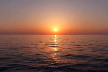 Naklejka premium Sunset over a calm ocean, soft hues of orange and pink