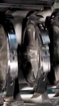 Industrial printing machine processes paper sheets on conveyor belt line. Modern typography production with fast press equipment. Technology for publishing, packaging and mass printing