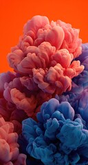 Obraz premium Abstract ink blossoms in vibrant pink and blue, swirling against an orange backdrop