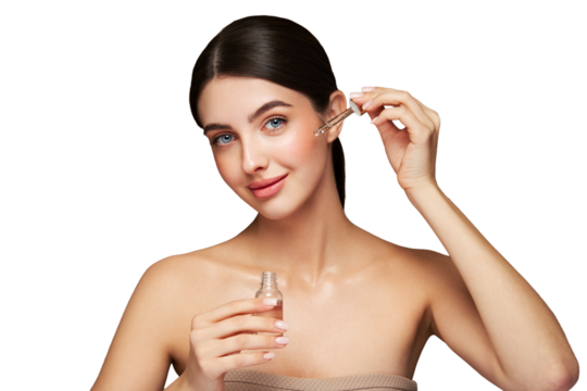 Young beautiful woman applying face serum with pipette. Cosmetic procedures for facial skin care
