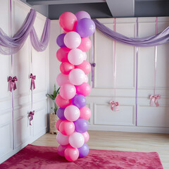 Multicolored balloons in the shape of a spiral column in the room.