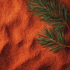 Red sand textured surface with pine sprigs