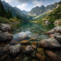 Crystal-clear mountain lake nestled amongst towering peaks.  Tranquil alpine scenery, with rocks lining the shore and lush greenery in the background.  Sunlight filters through clouds
