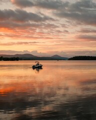 Fototapeta premium A boat on Lake Memphremagog at sunset in Newport, Vermont