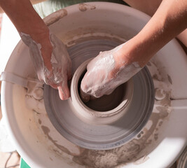 Manos trabajando la ceramica en el torno