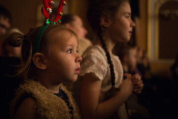 children watch a theatre performance attentively. play, Christmas holidays