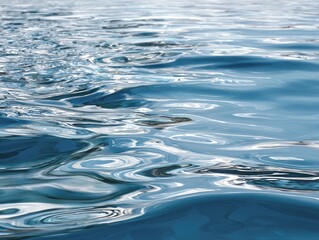 Fototapeta premium Close-up view of rippling ocean water, displaying intricate patterns of light and reflection