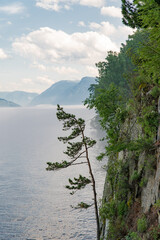 The surface of a mountain lake in calm weather with fog rising from the surface