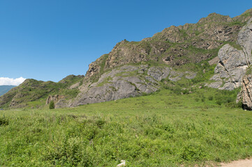 Mountain landscape against a bright blue sky.