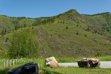 Mountain landscape against a bright blue sky.