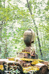 Fototapeta premium Stone urn statue with draped detail stands as a solemn memorial