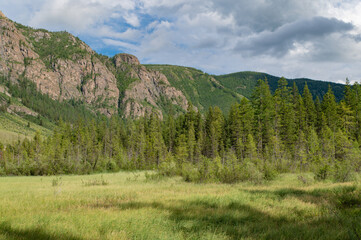 Mountain landscape against a bright blue sky.