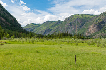 Mountain landscape against a bright blue sky.