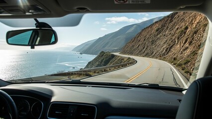 POV from inside car looking out at winding coastal road, ocean waves, and cliffs under bright daylight. Scenic seaside adventure and travel lifestyle concept.