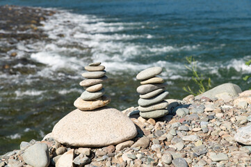 A pyramid made of flat stones on the river bank