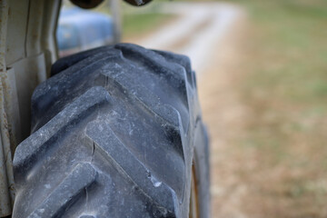A close-up image of a tire on a tractor on a farm