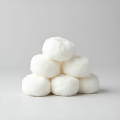 Soft and fluffy round cotton pads stacked neatly in a pile.