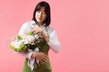 Florist with beautiful bouquet of flowers on pink background, space for text