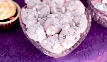 Detail shot of animal-shaped marshmallow cookies in a bowl, designed as gray mice and bears with pink accents, perfect for children’s parties.