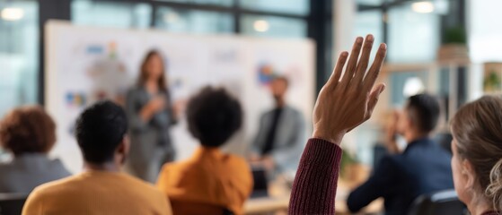 The engaged audience raising hands during a professional seminar discussion session.