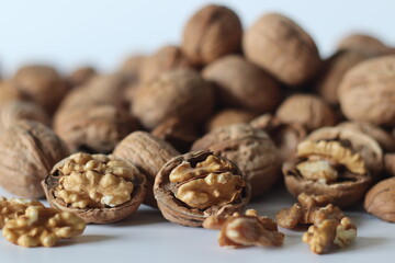 Walnuts in shell and cracked with exposed kernels. Winter diet, theme of nutrition, tradition