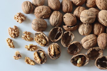 Walnuts in shell and cracked with exposed kernels. Winter diet, theme of nutrition, tradition