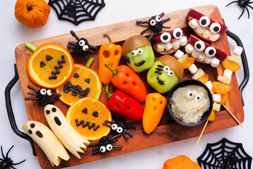 Healthy Halloween fruit and vegetable platter. Assortment of fun, spooky treats. Top view table...